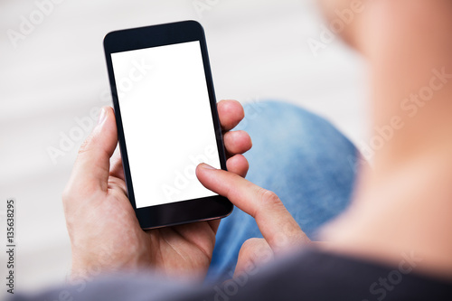 Man's Hand Holding Cell Phone With Blank Screen