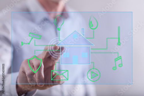Man touching a digital smart home automation concept on a touch