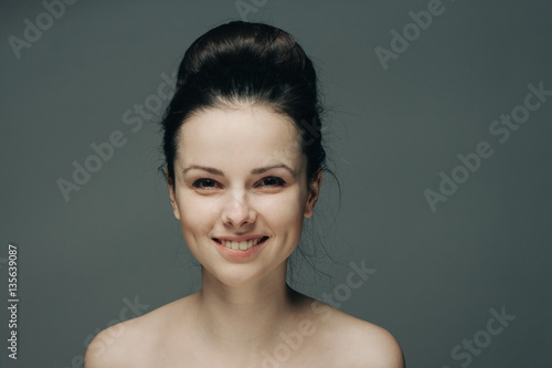 beautiful smile, happy woman on a gray background