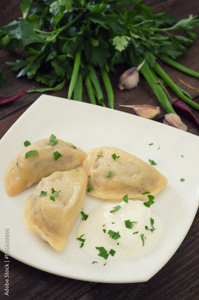 Dumplings with the liver. Wooden background. Top view Dumplings with the liver. Wooden background. Top view