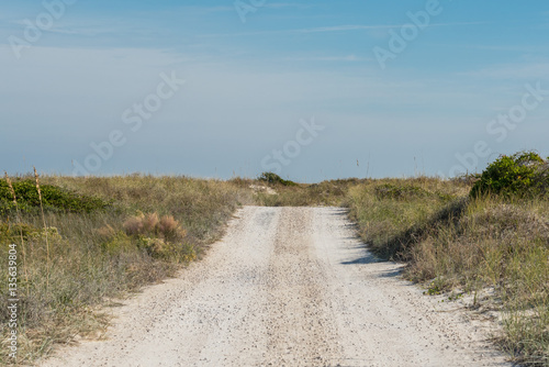 Dirt Road Rolls Over Sand Dunes