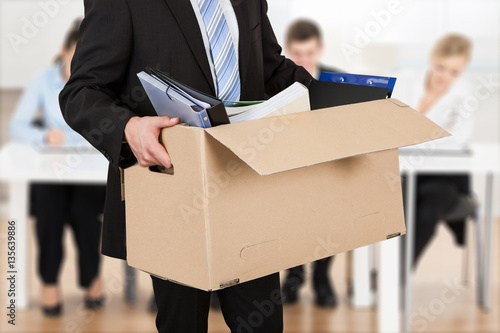 Bild auf Leinwand Businessperson Carrying Cardboard Box