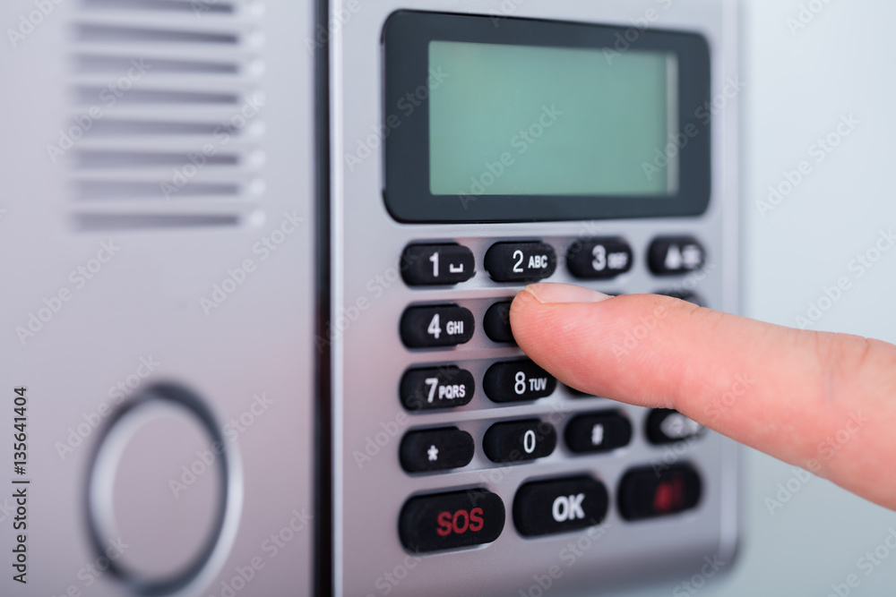 Person's Finger Setting Security Alarm Person's Finger Setting Security Alarm