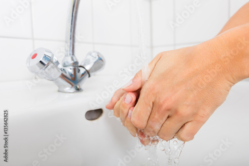 Woman Washing Hand In The Basin