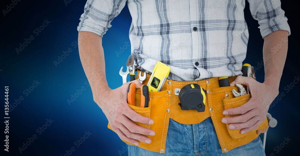Mid section of handyman with tool belt around his waist Mid section of handyman with tool belt around his waist