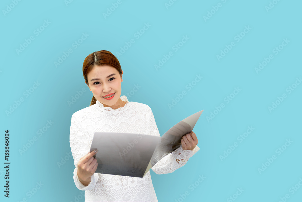The pretty Asian business women hold the folder with the light green background. The pretty Asian business women hold the folder with the light green background.