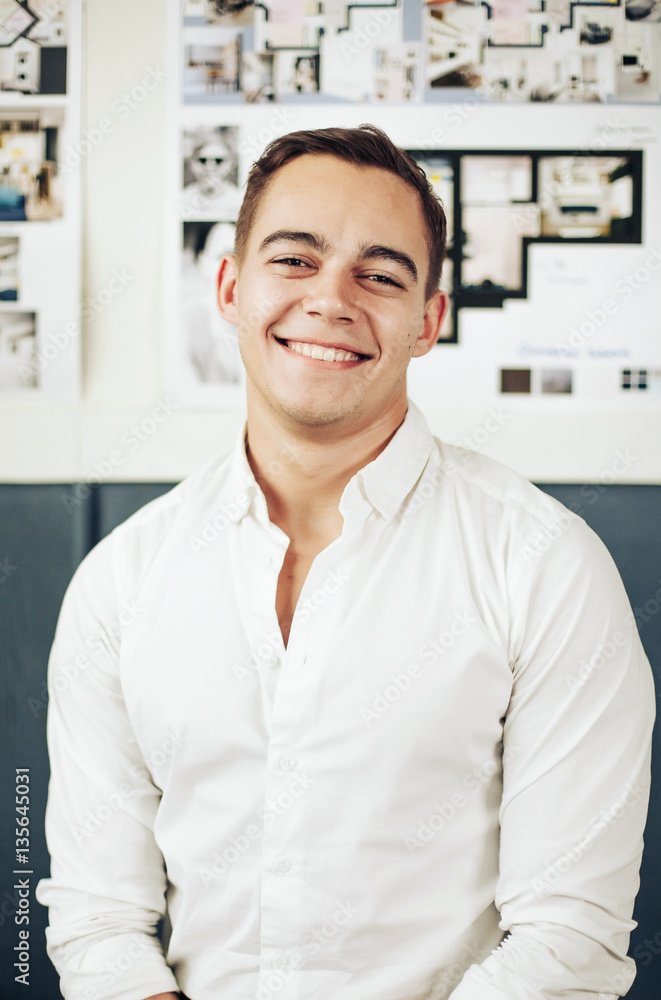 Portrait of a smart young man standing with arms crossed Portrait of a smart young man standing with arms crossed