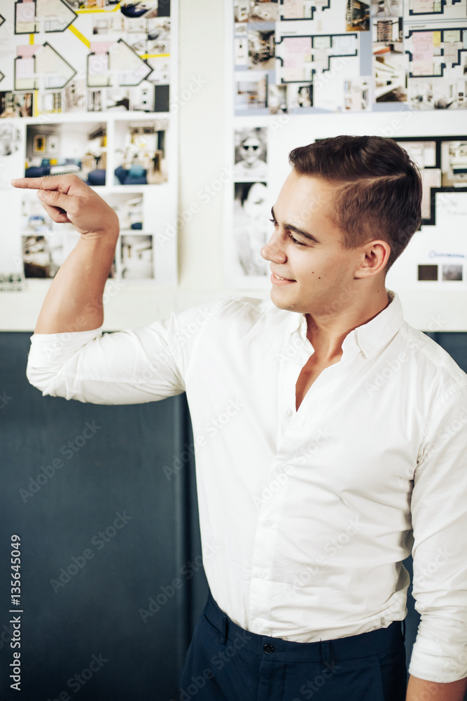Fototapeta premium Portrait of a smart young man standing with arms crossed