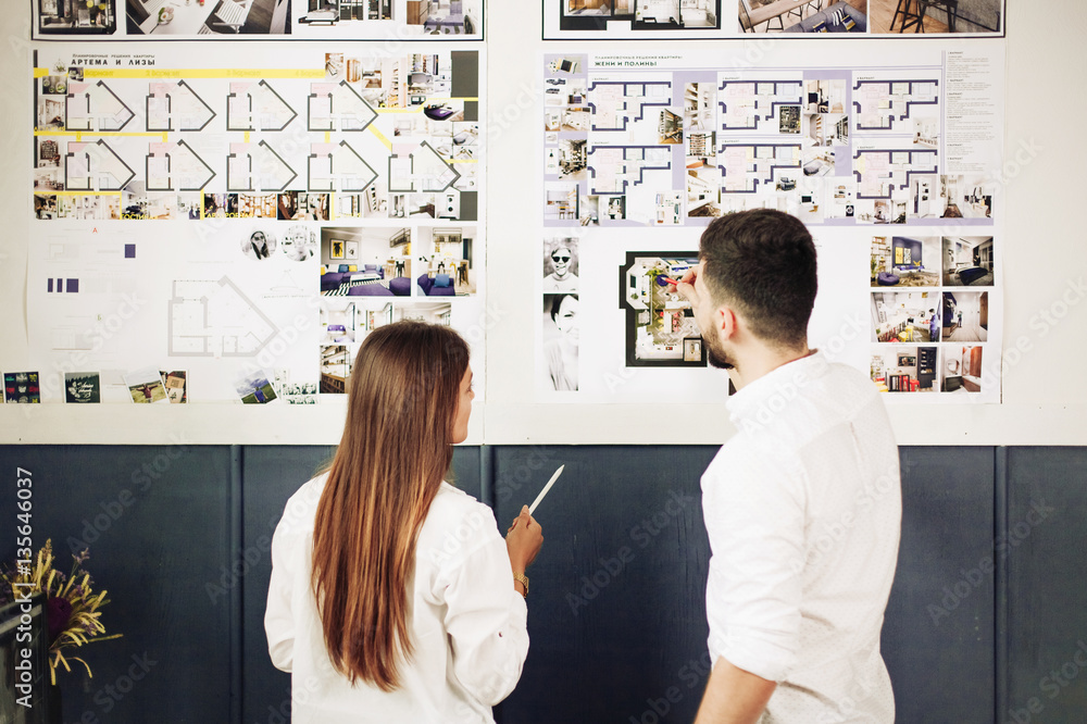 Two architects discussing new project at modern office Two architects discussing new project at modern office