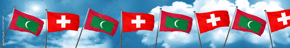 Maldives flag with Switzerland flag, 3D rendering Maldives flag with Switzerland flag, 3D rendering