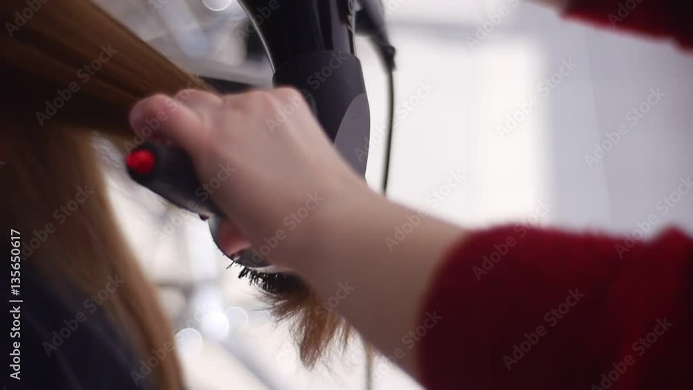 Blow-Drying of Hair Ends Close View Professional Hairdresser Styles the Client's Long Hairs Makes Hair Smooth and Healthy Hair Dryer Styling Damaging Hairs Blow-Drying of Hair Ends Close View Professional Hairdresser Styles the Client's Long Hairs Makes Hair Smooth and Healthy Hair Dryer Styling Damaging Hairs