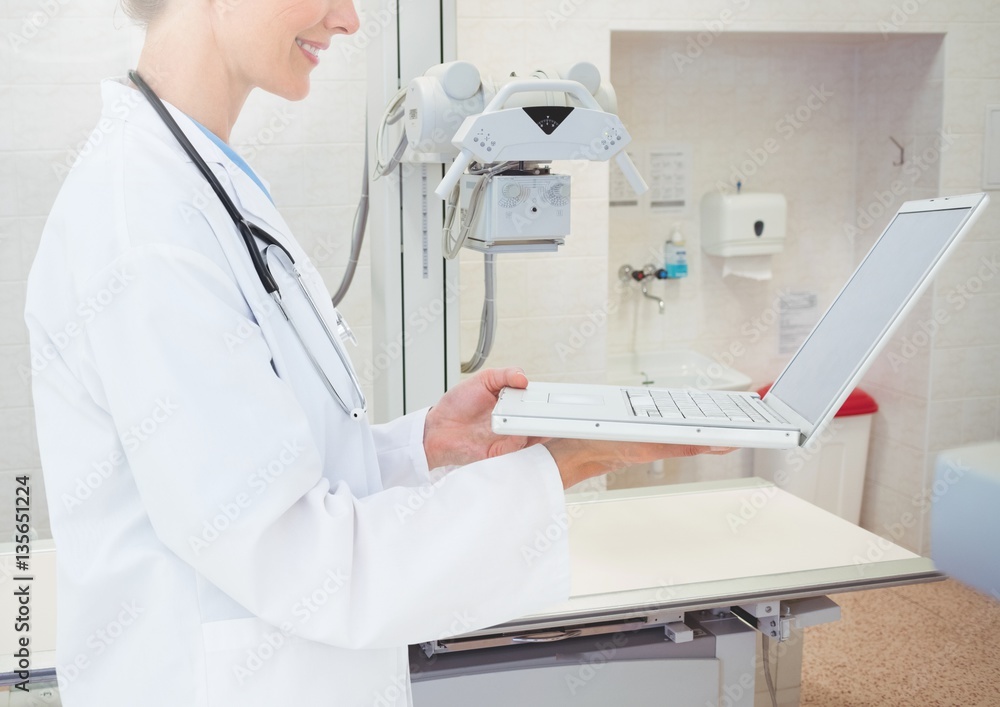 Mid section of doctor using laptop Mid section of doctor using laptop