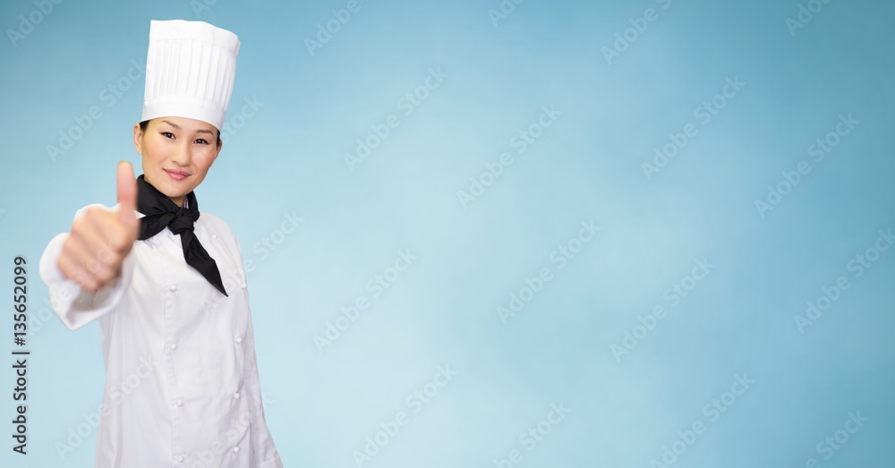 Smiling female chef giving thumbs up sign