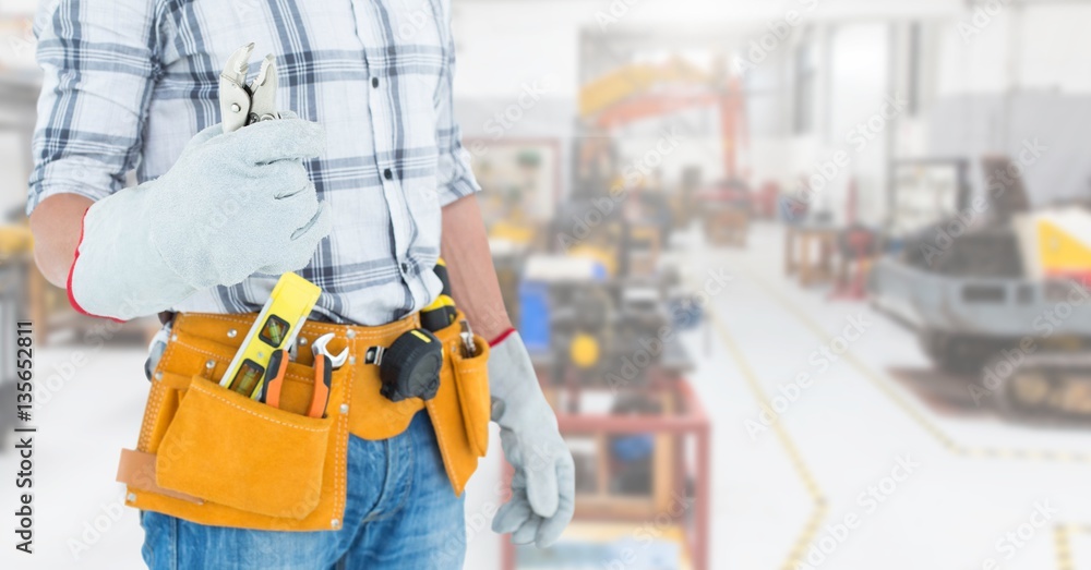 Handyman with tool belt at workshop