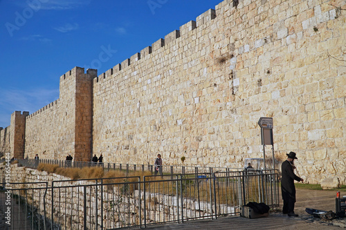 JERUSALEM -   A busker in hassidic garb plays klezmer music beside the Old City walls approaching Jaffa Gate. photo