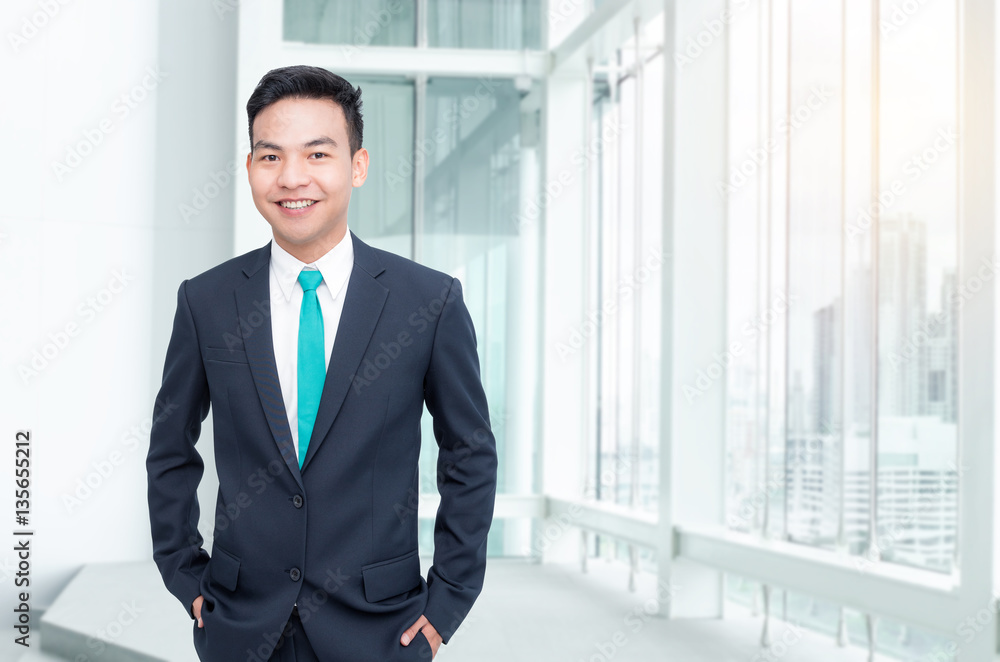 Handsome asian businessman standing in office Handsome asian businessman standing in office