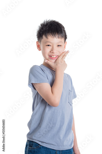 Young asian boy smiling over white background