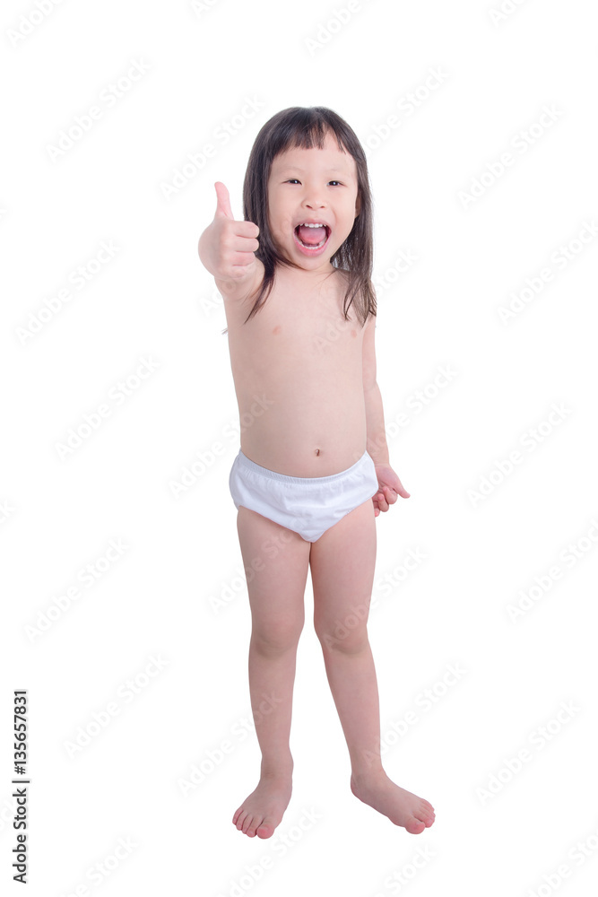Little asian girl in white panties smiles and showing thumb up Stock Photo