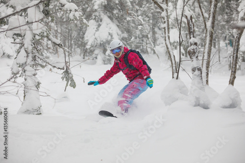 Snowboarder freeride jump in powder.