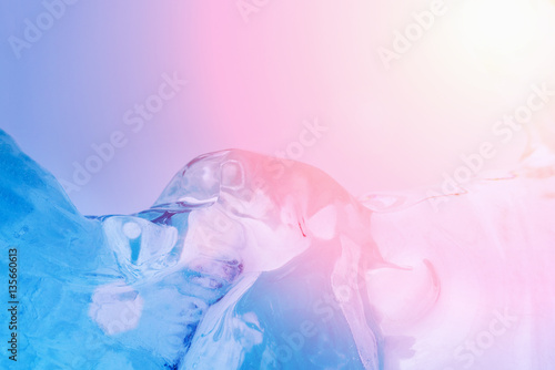 Blue ice with bubbles in the sunlight, background