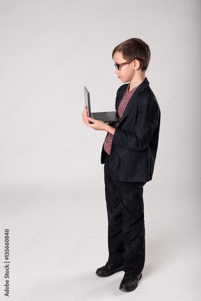Portrait of business child in glasses using laptop Portrait of business child in glasses using laptop