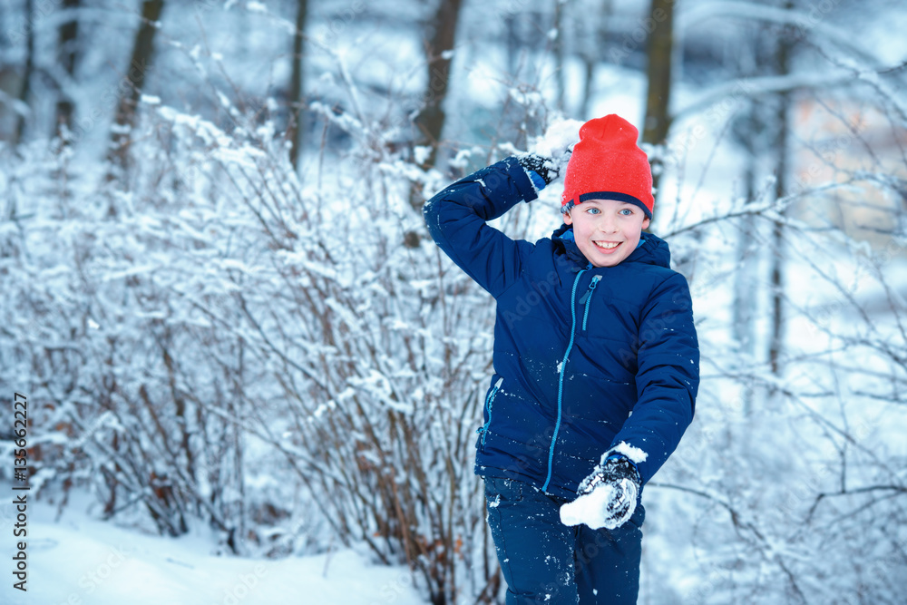 Cute little boy having fun with snowball fight winter Cute little boy having fun with snowball fight winter