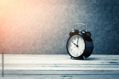 Papier peint black alarm clock on wooden floor and grey background with free