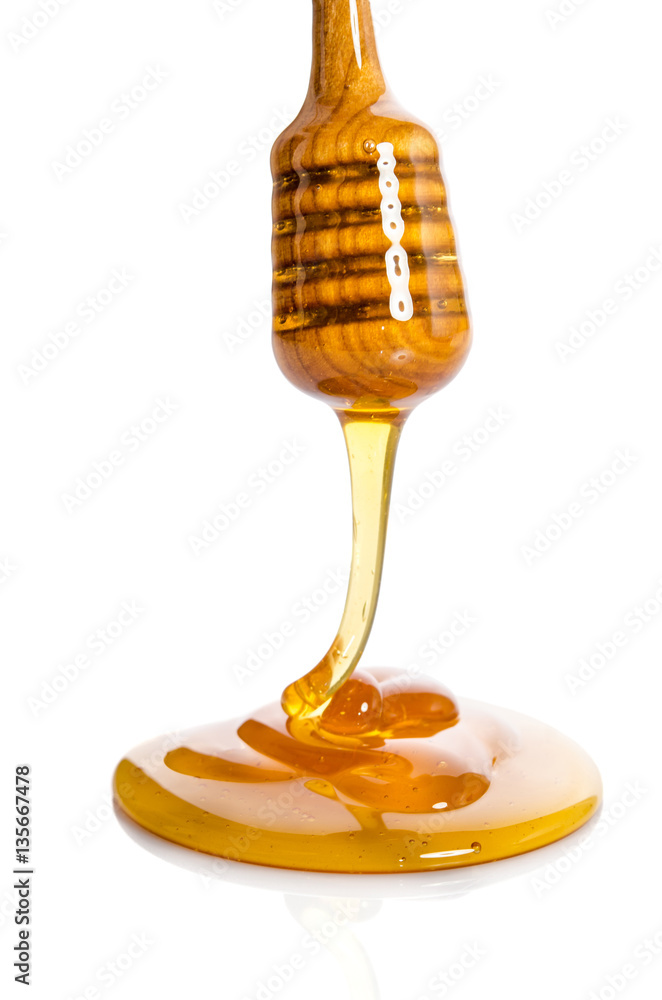 Honey dripping from a wooden honey dipper Honey dripping from a wooden honey dipper