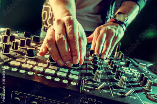 DJ playing music at mixer closeup photo