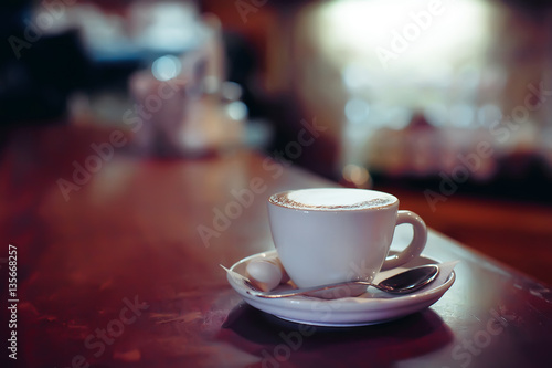 Cup of cappuccino on the table, blurry background