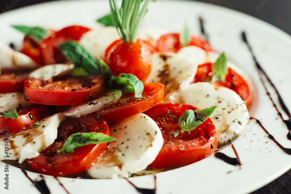 Appetizer with feta and tomatoes on dish Appetizer with feta and tomatoes on dish