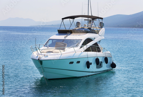 Obraz na plátně Luxury yacht in azure seas parked in a beautiful blue bay