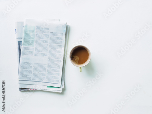 Photos Top view newspaper and coffee mug on white desk