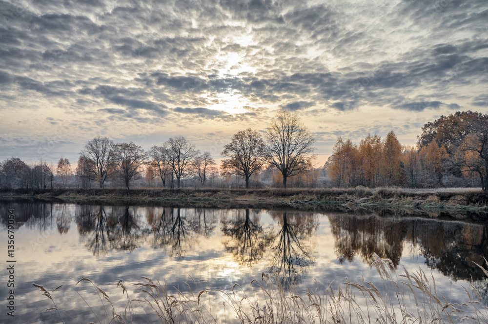 Surface of the autumn river. Dawn. Oakwood. Surface of the autumn river. Dawn. Oakwood.