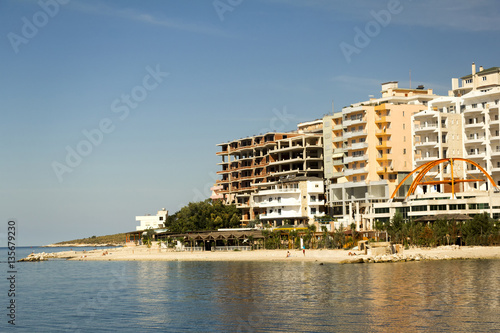 Adriatic coast with the sea and the town (Albania). Coast Resort. © kordeo