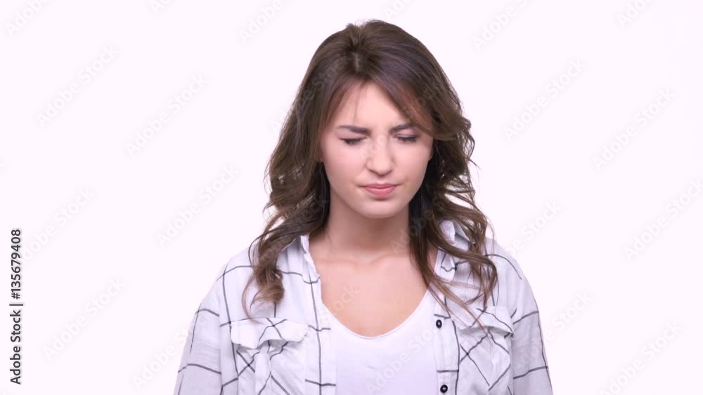 Young confused woman with good eyesight putting off eyeglasses isolated Young confused woman with good eyesight putting off eyeglasses isolated
