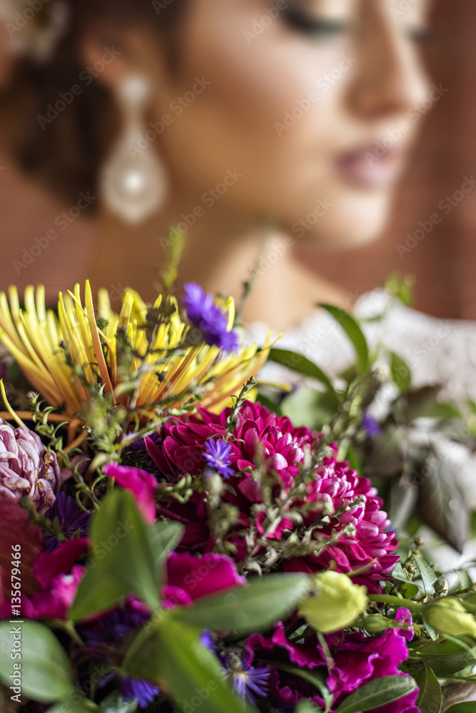 Brides bouquet of autumn flowers in burgundy tones.
