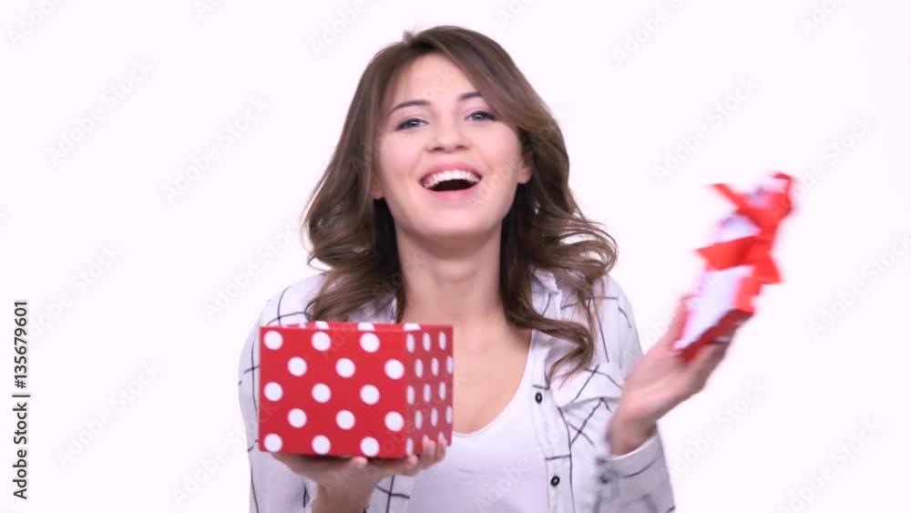 Cheerful happy woman opening gift box isolated on a white background Cheerful happy woman opening gift box isolated on a white background