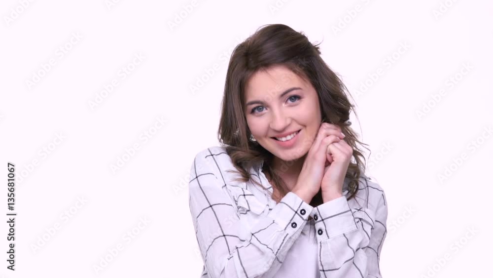 Beautiful young woman sending air kiss to camera while standing against white background Beautiful young woman sending air kiss to camera while standing against white background