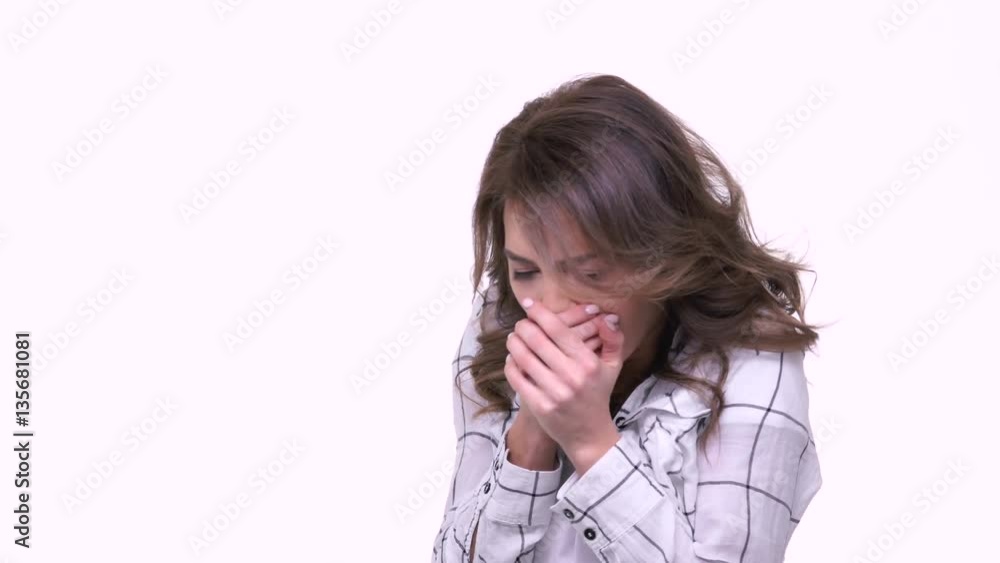 Beautiful young woman freezing while keeping arms crossed and standing isolated on white Beautiful young woman freezing while keeping arms crossed and standing isolated on white