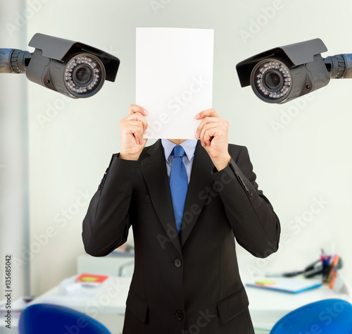 businessman covering his face at the office