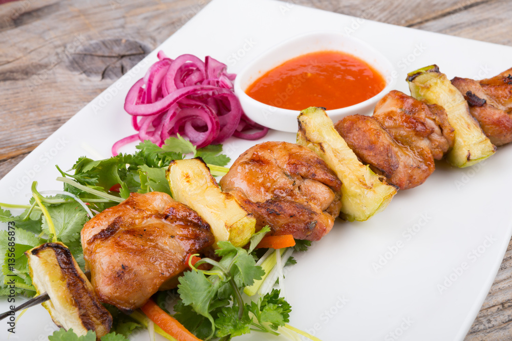 Fried meat on a metal skewer