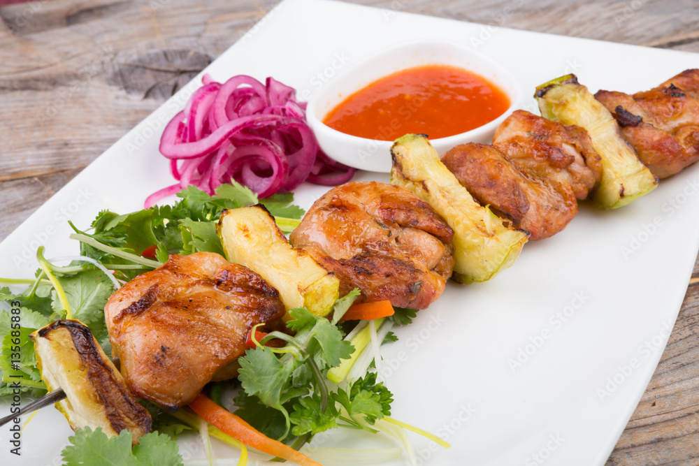 Fried meat on a metal skewer