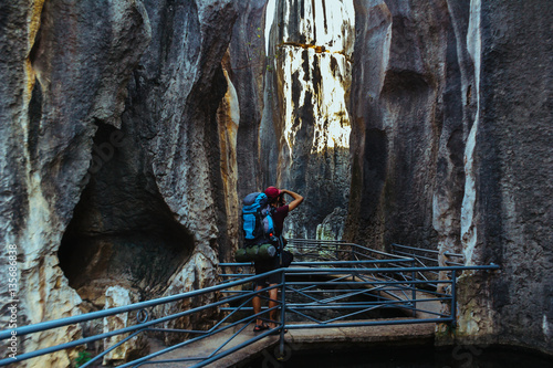 Boy exploring Stone Forest in Shilin, Yunnan Province, South China, not far from the Kunming. It is the world-famous natural area of limestone formations and UNESCO World Heritage Site. © Iryna