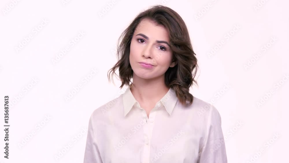 Confused puzzled girl gesturing with hands and looking at the camera isolated on white background Confused puzzled girl gesturing with hands and looking at the camera isolated on white background