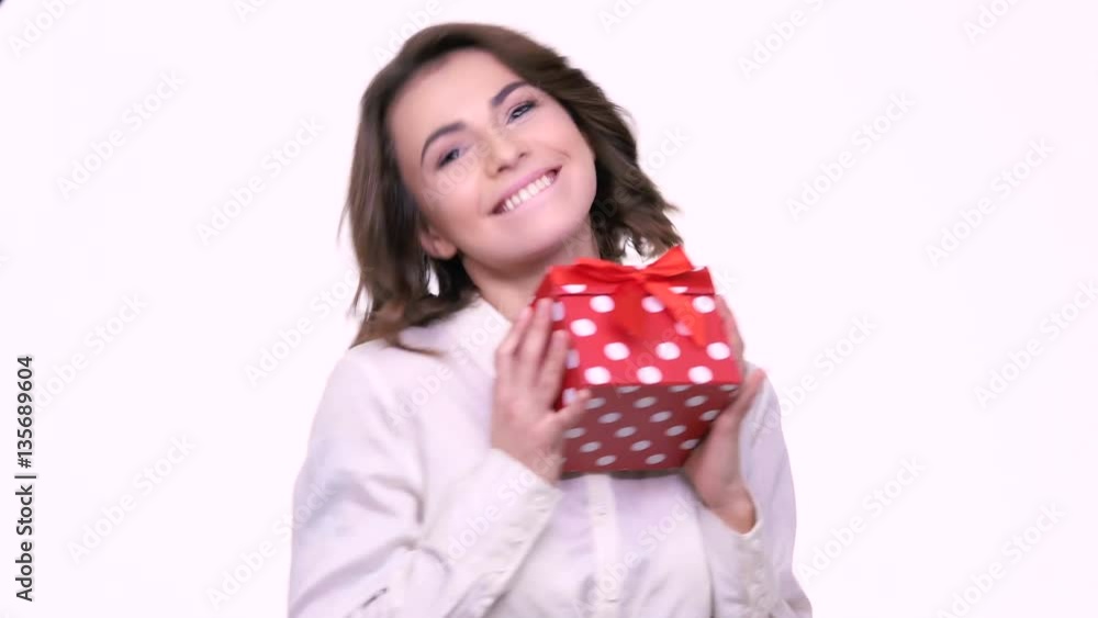 Happy wondered woman holding gift box isolated on the white background Happy wondered woman holding gift box isolated on the white background