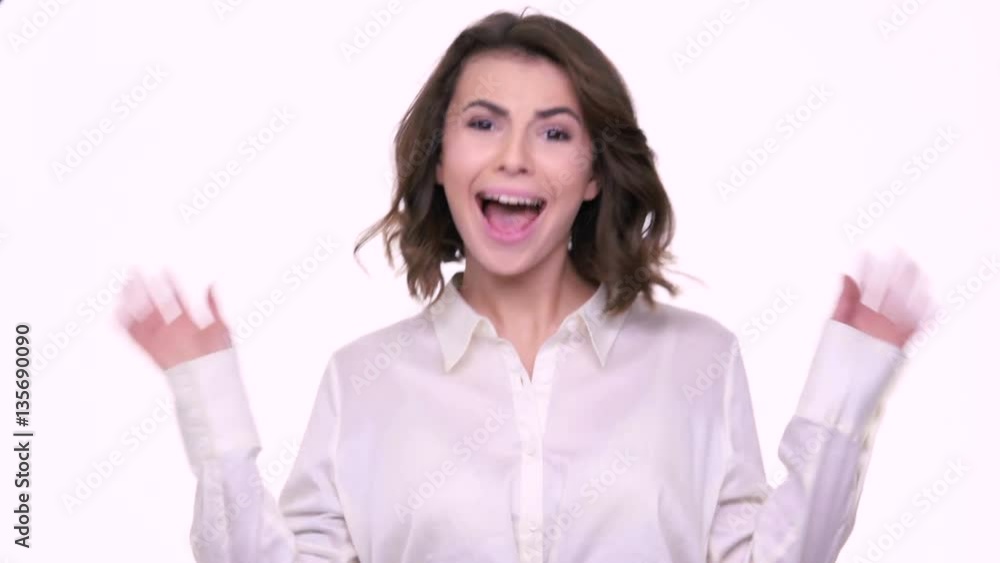 Happy smiling beautiful woman meeting a friend and waving her hand isolated on a white background Happy smiling beautiful woman meeting a friend and waving her hand isolated on a white background