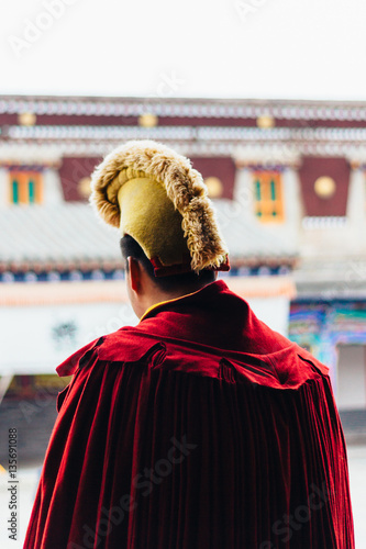 QINGHAI, CHINA - October 4, 2016: Tibetan monk wearing Yellow Hat (Gelug) in the ancient temple building architecture of Kumbum monastery in Qinghai Province, China