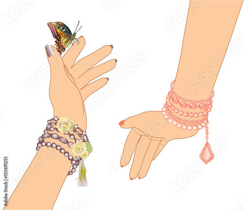 woman's hands with bracelets of beads and a butterfly