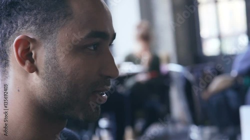 Wallpaper Mural Young multiethnic guy talking with his friends at coffee shop Torontodigital.ca